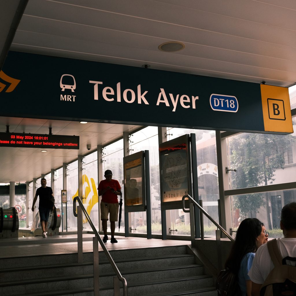 Telok Ayer MRT signage in Singapore, indicating a portion of a mass transit rail line - an example used to convey government injection and domestic spending