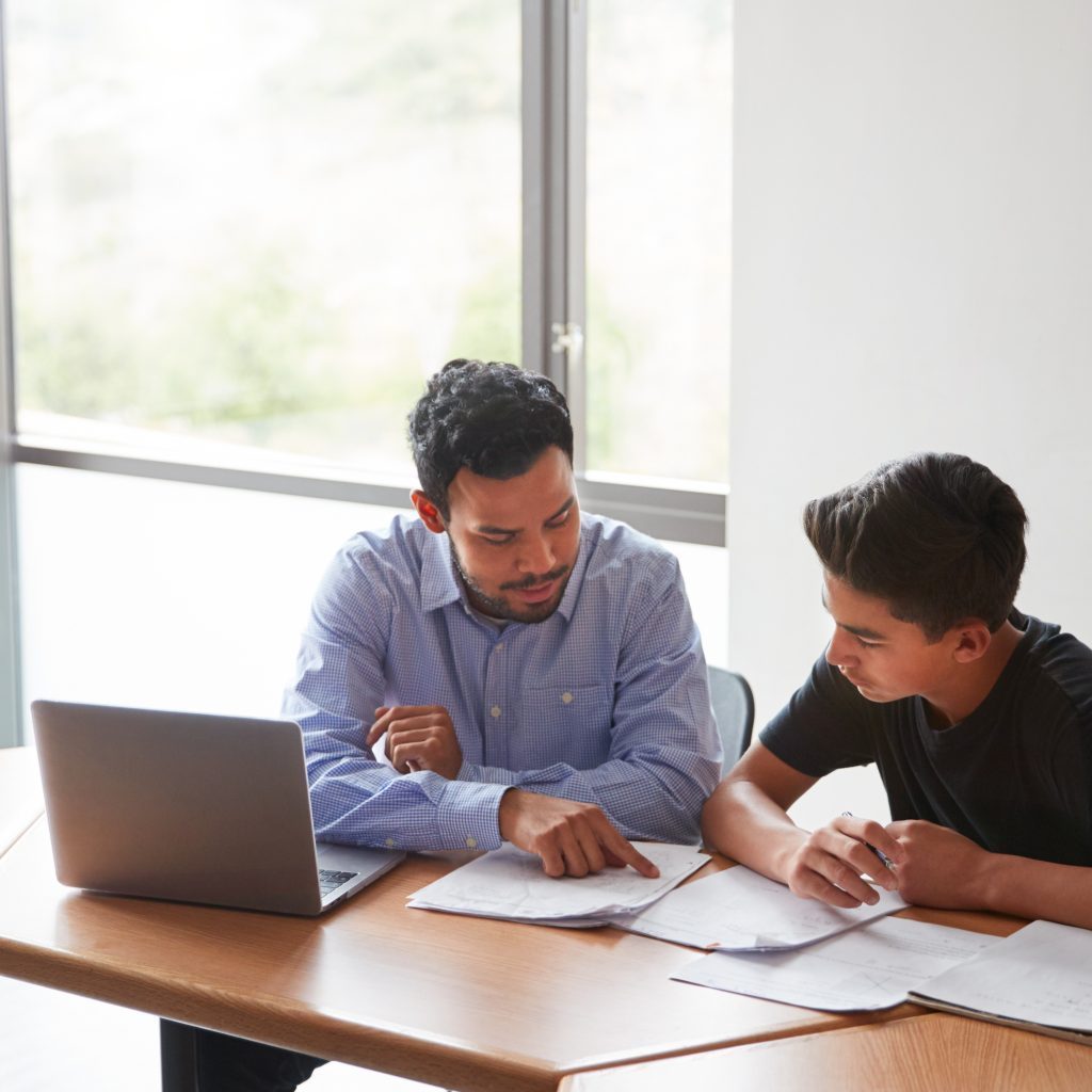a tutor from a top economics tuition centre tutoring a student
